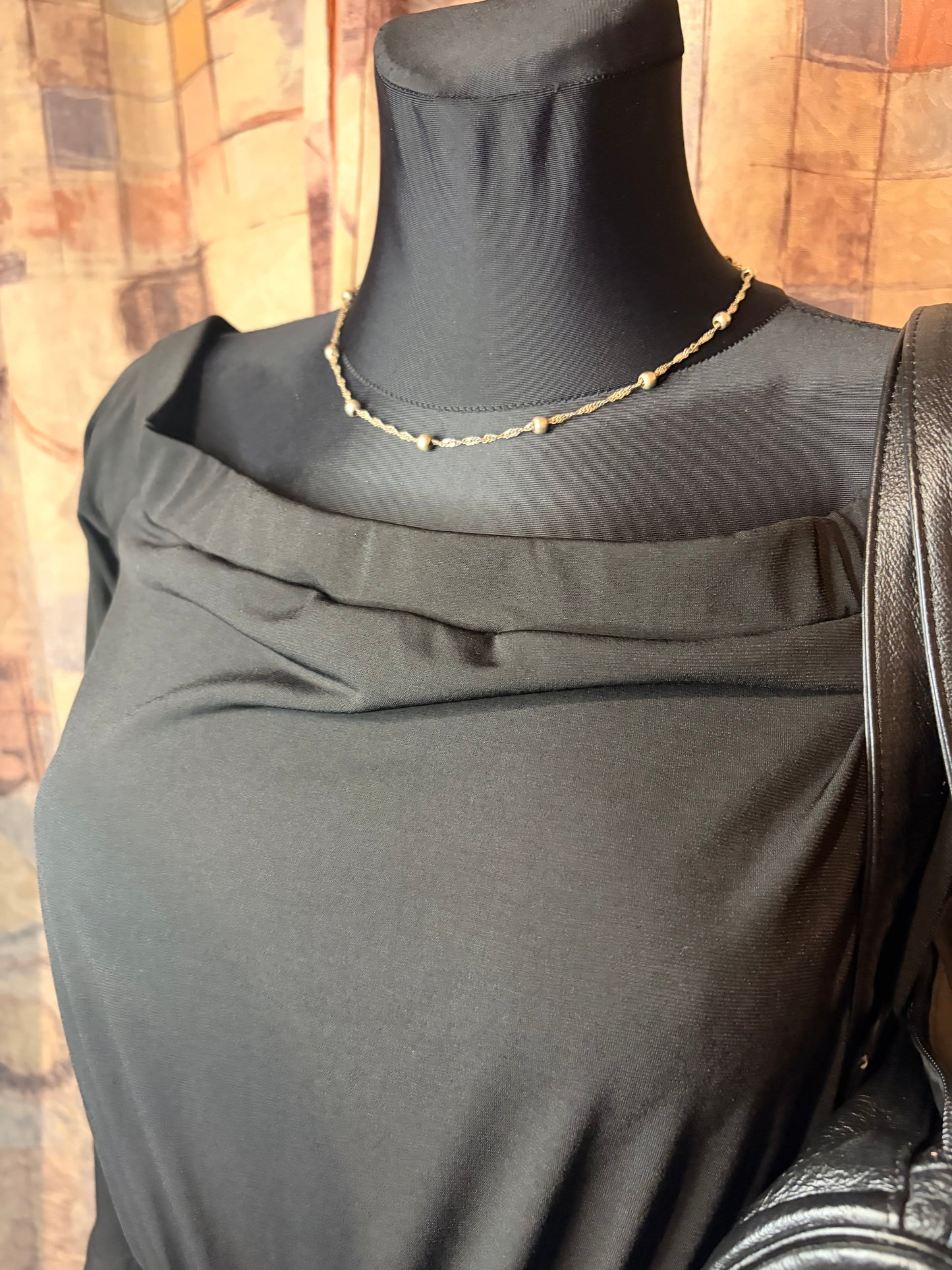 Black long-sleeve off-shoulder mini jumpsuit