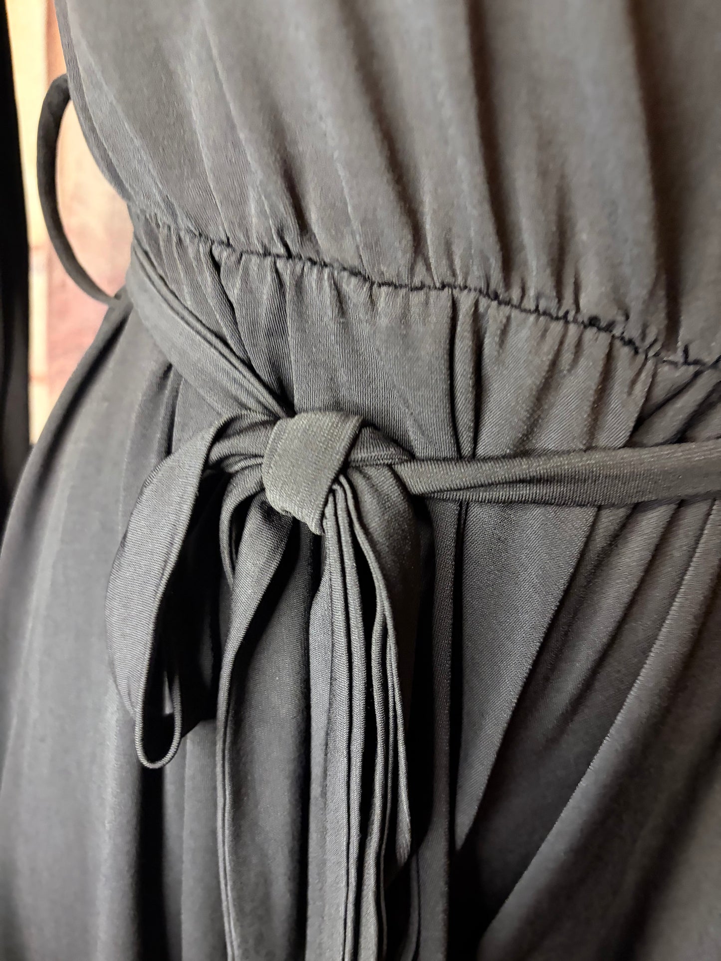 Black long-sleeve off-shoulder mini jumpsuit